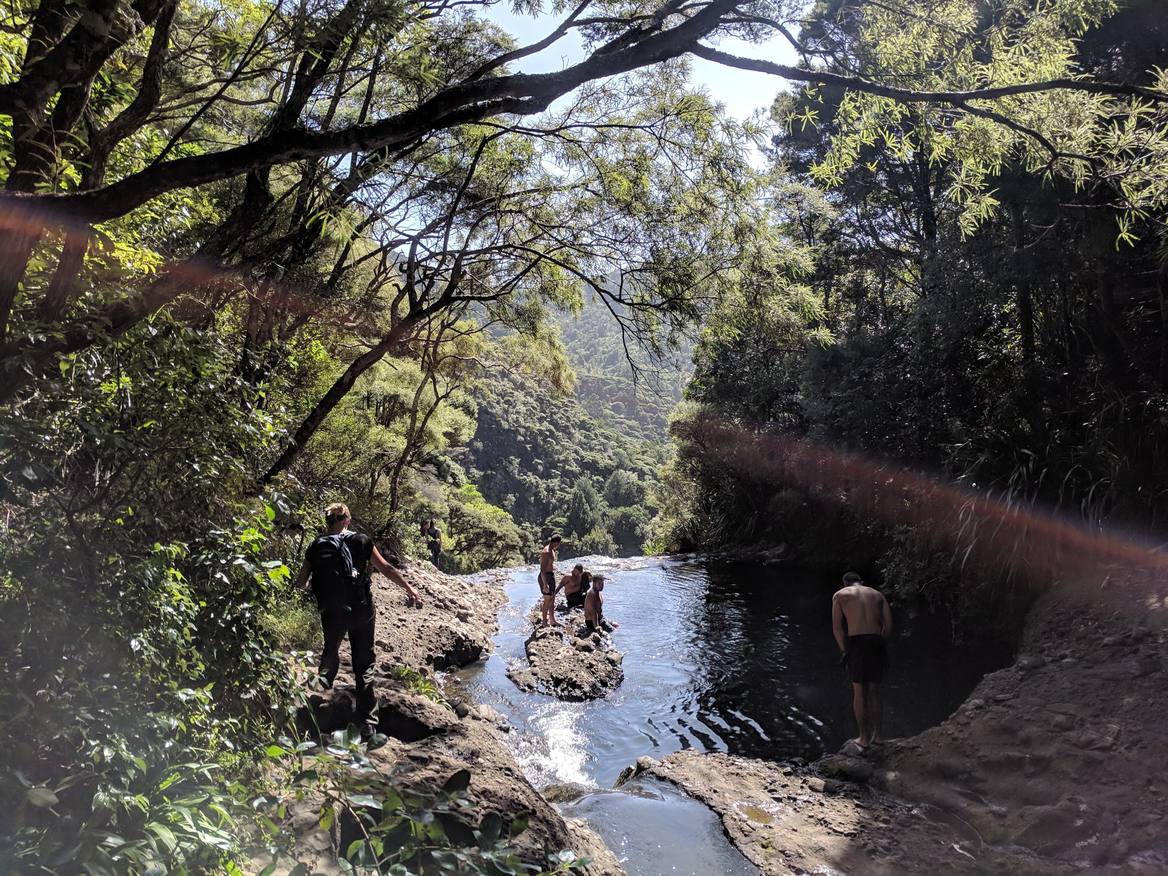 People hanging out at the top of Kitekite falls