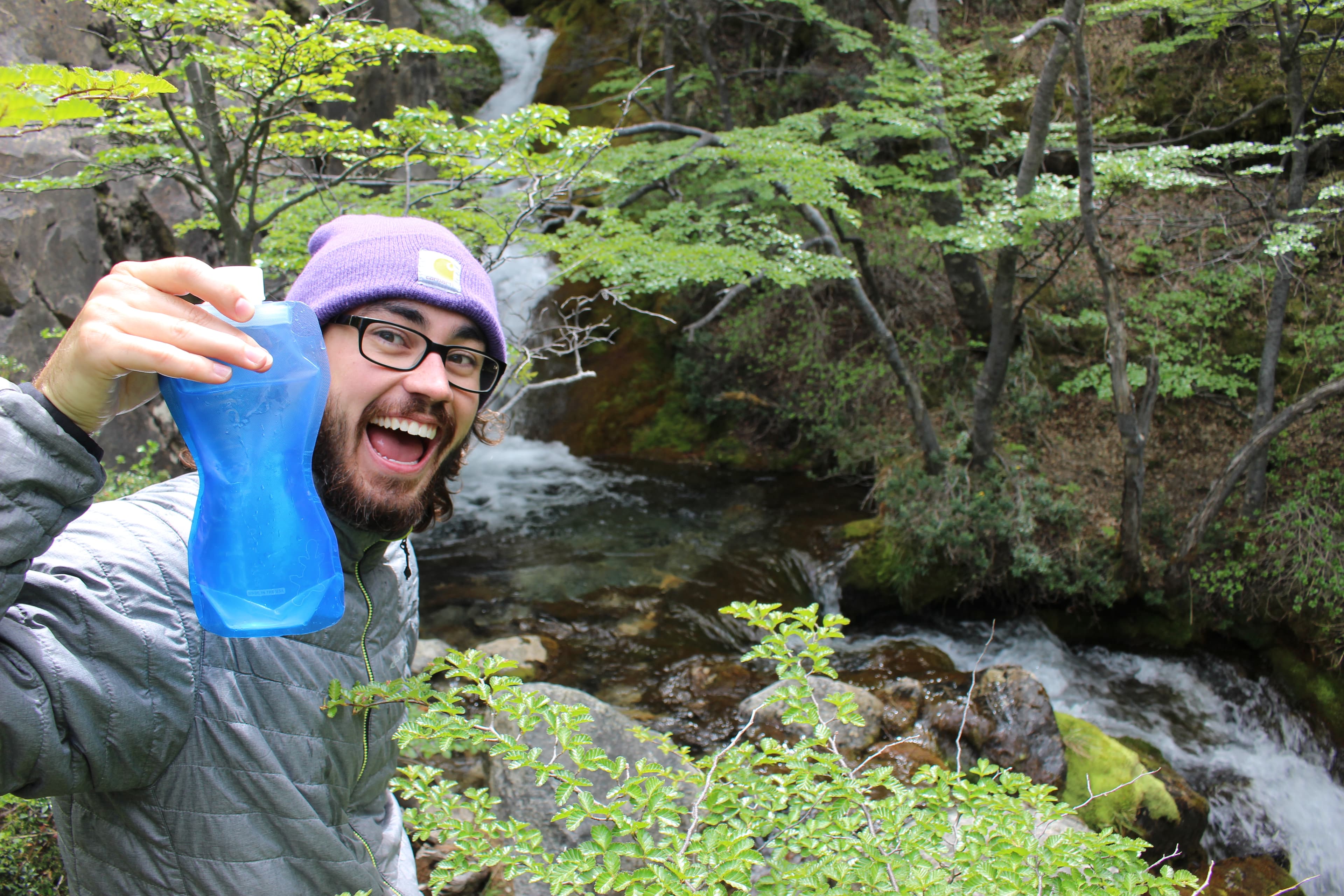 Filling water bottles with mountain water