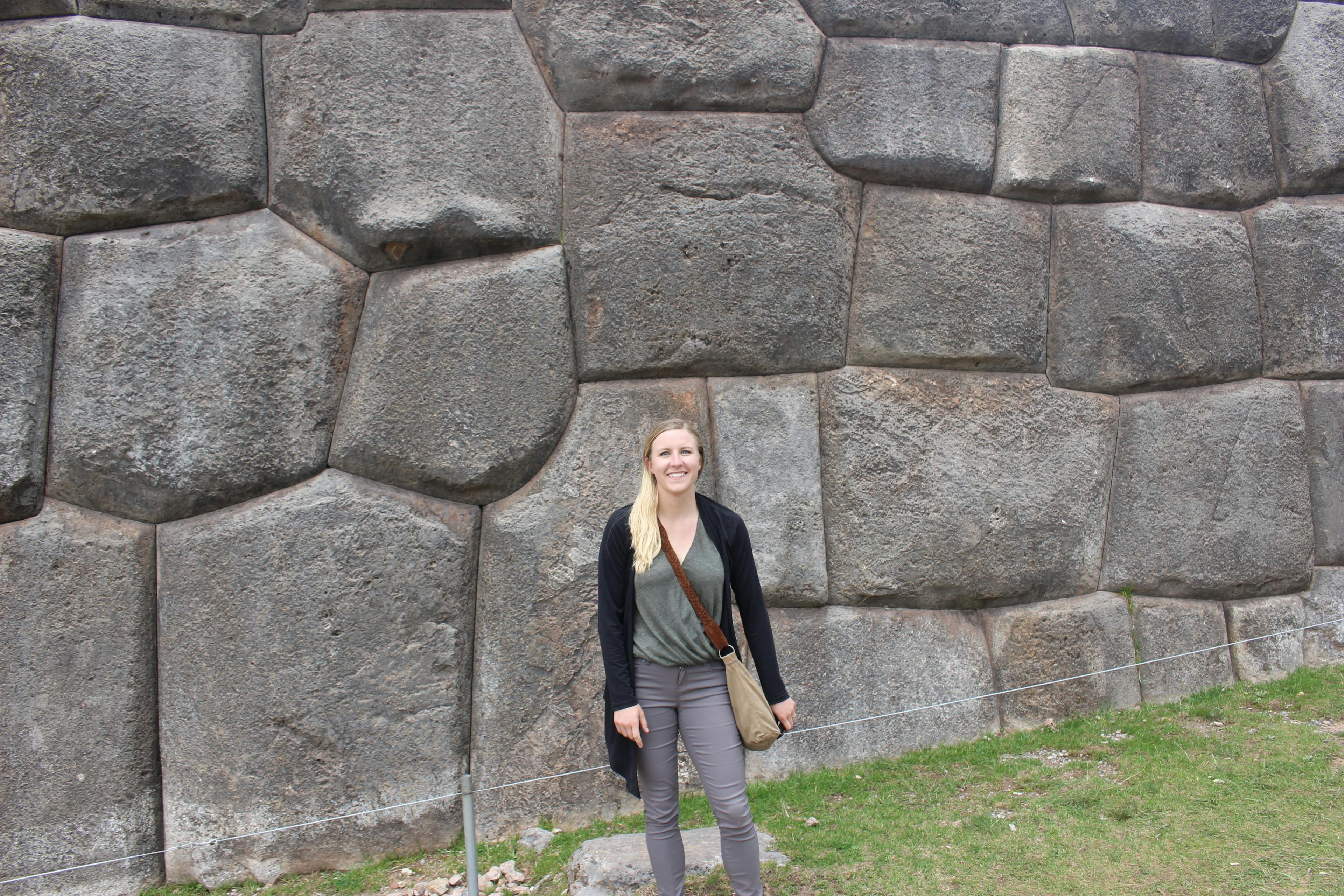 Lauren in front of blocks at Sacsayhuamán