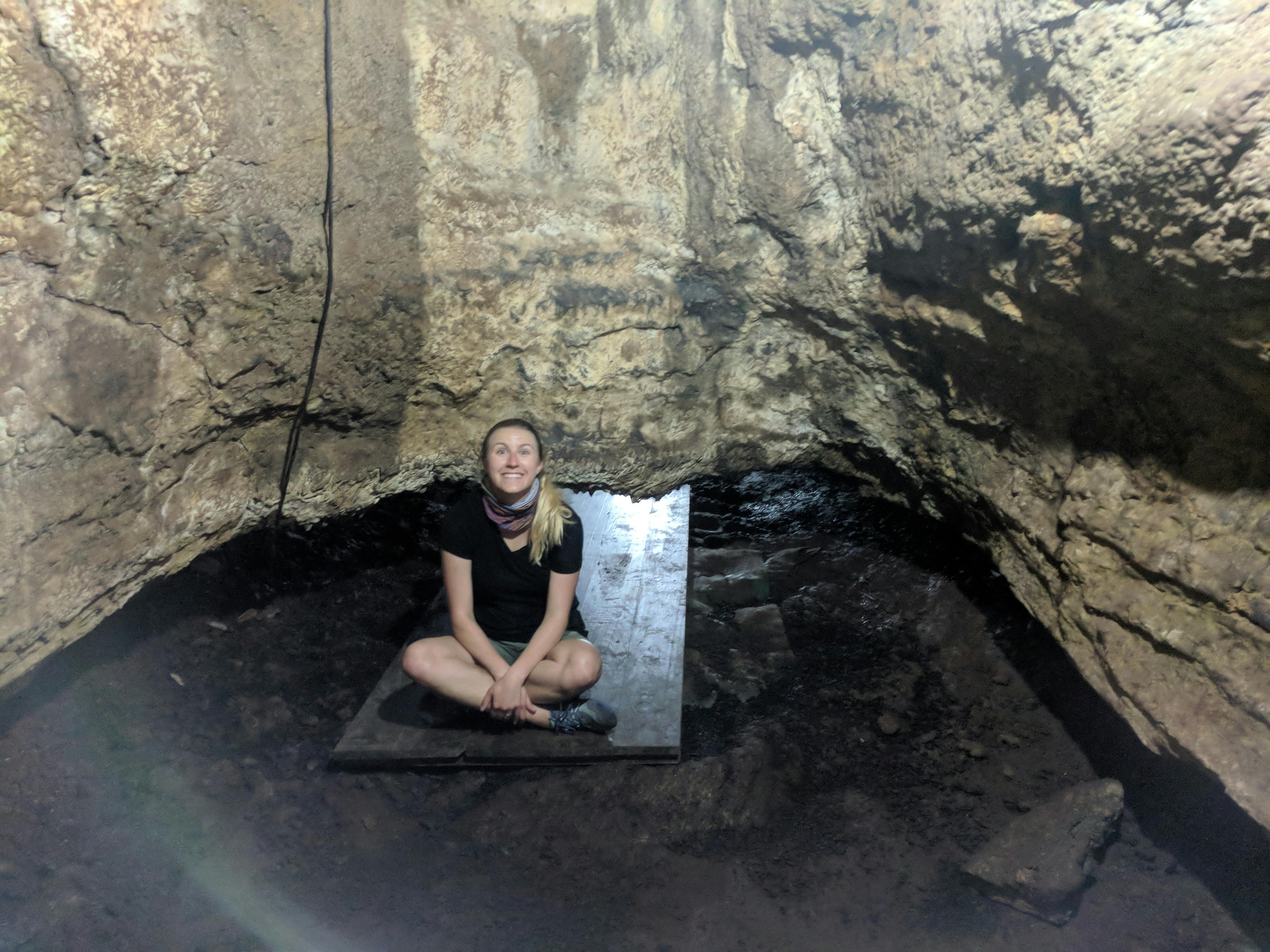 Lauren squeezing through the lava tunnels