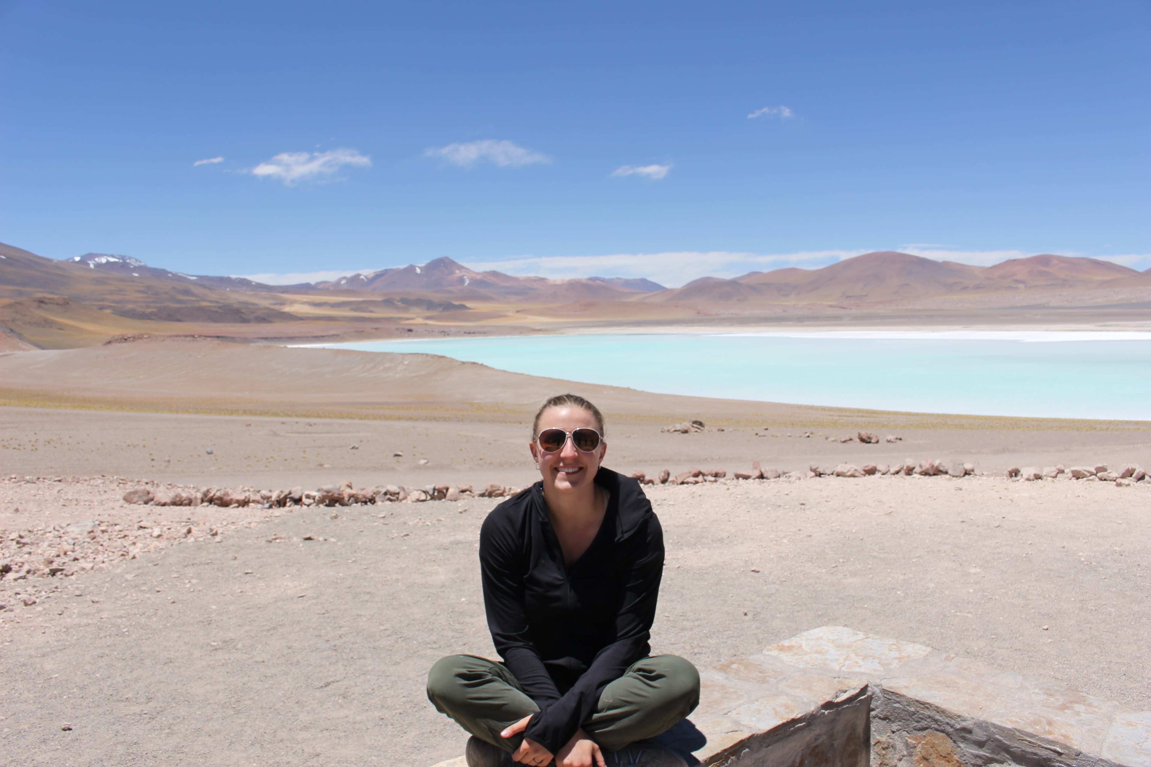 Lauren doing a classic cross-legged sit next to Laguna Tuyaito