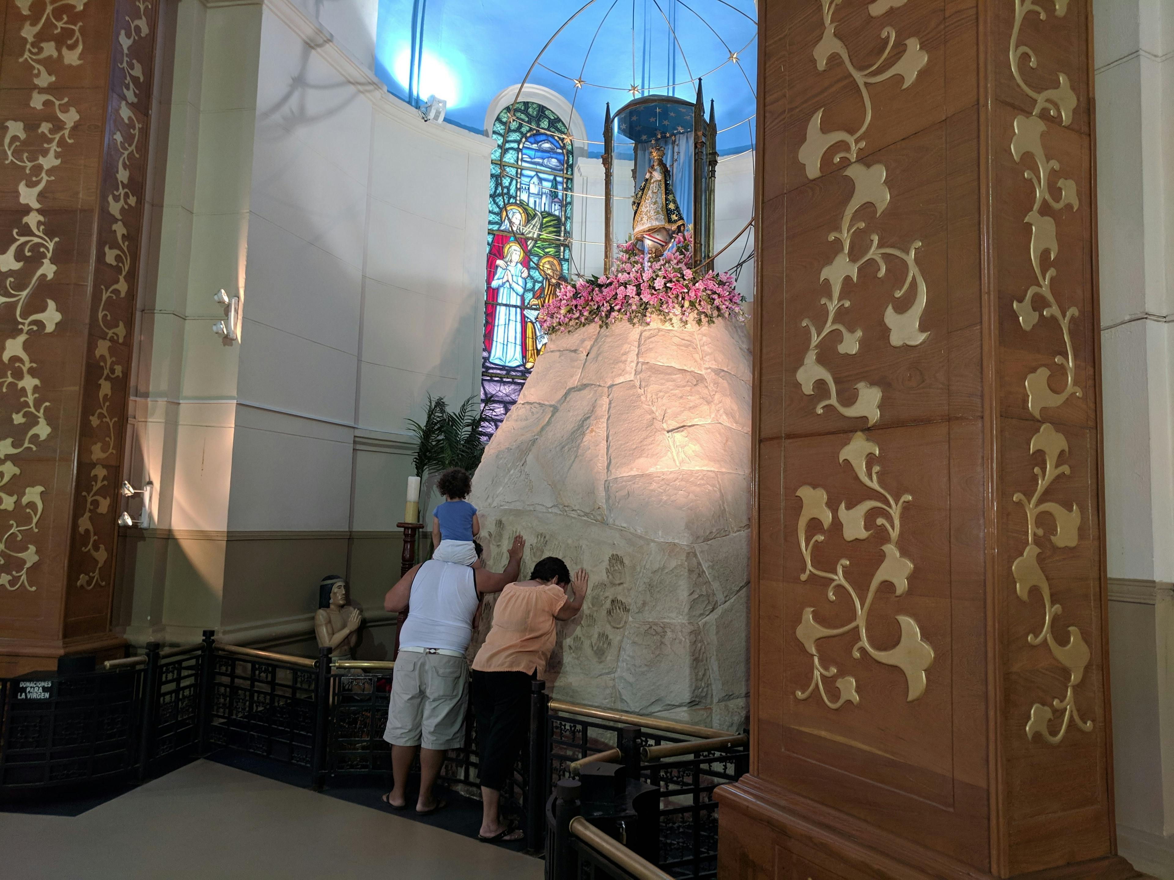 People praying at the Virgen de Caacupé